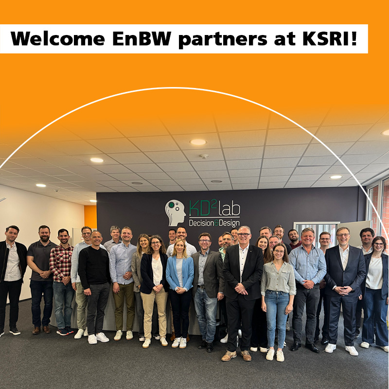 Group of people standing in front of KD²Lab sign at KSRI-EnBW event.